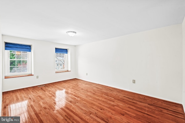 unfurnished room featuring hardwood / wood-style floors