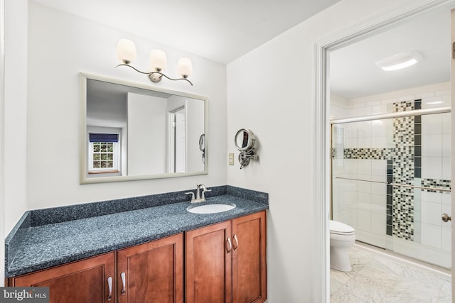 bathroom featuring toilet, an enclosed shower, and vanity