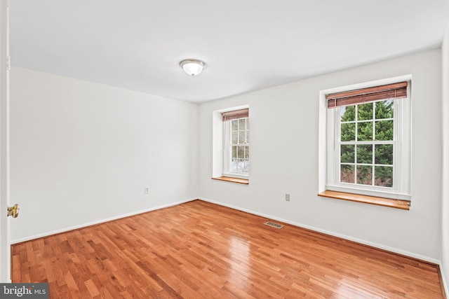 unfurnished room with light wood-type flooring