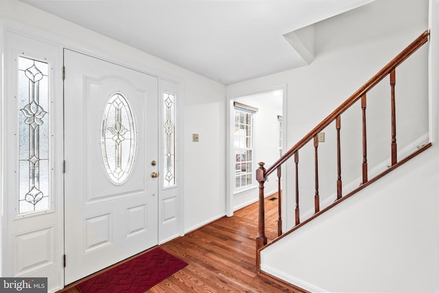 foyer entrance featuring a healthy amount of sunlight and hardwood / wood-style flooring