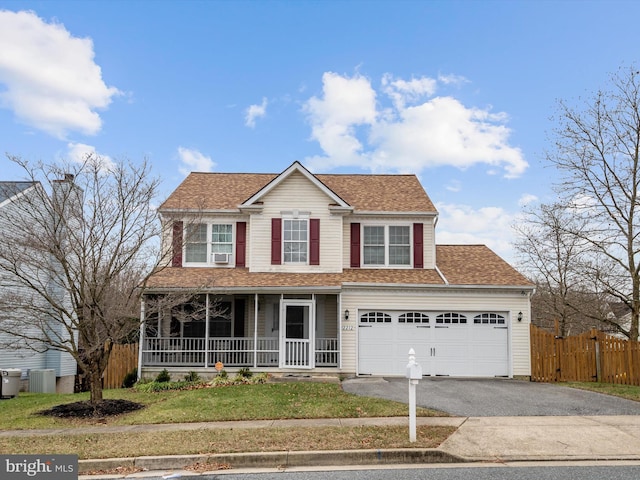 view of front of property featuring a front yard, a porch, and central AC