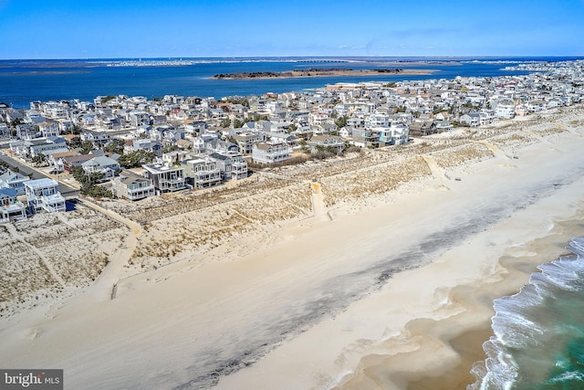 bird's eye view featuring a view of the beach and a water view