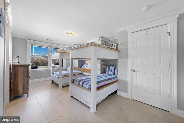 tiled bedroom featuring ornamental molding