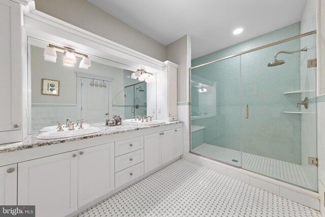 bathroom featuring an enclosed shower, vanity, and tile patterned floors