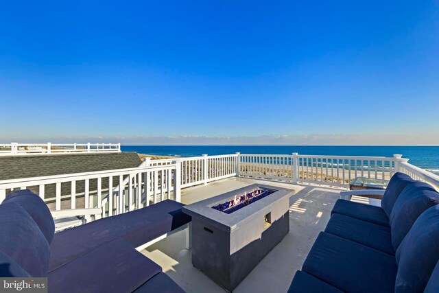 view of patio / terrace with a water view and an outdoor fire pit