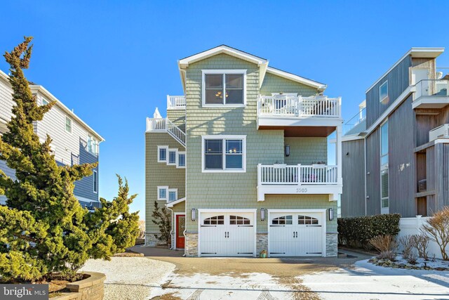 view of front of home featuring a garage and a balcony