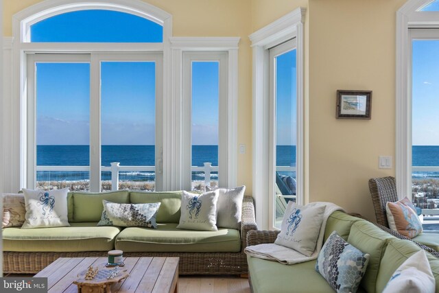 sunroom featuring plenty of natural light and a water view