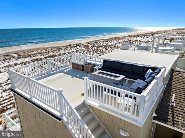 birds eye view of property featuring a view of the beach and a water view