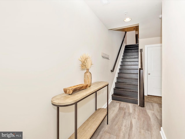 stairway with hardwood / wood-style floors