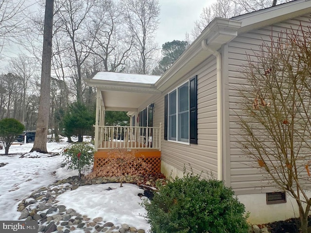 view of snow covered exterior with covered porch