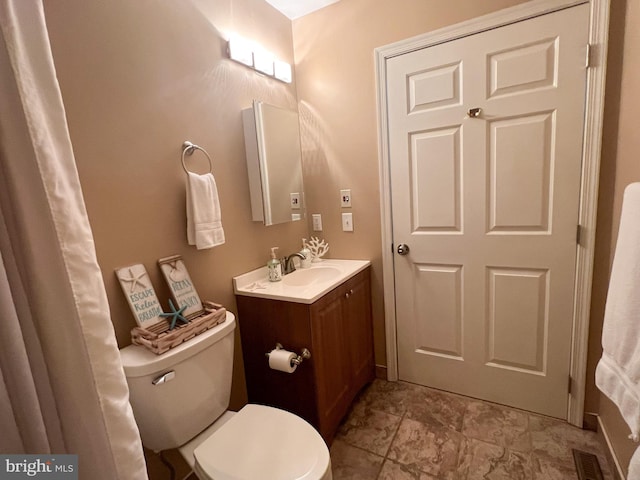 bathroom featuring toilet and vanity