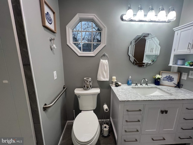 bathroom featuring tile patterned floors, toilet, and vanity