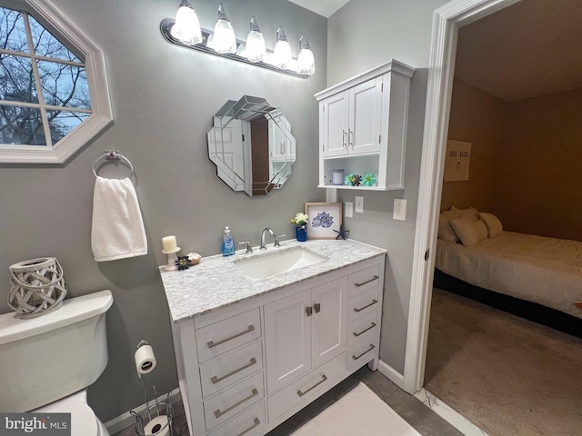 bathroom featuring toilet and vanity