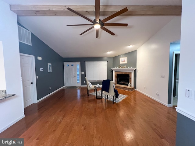 living room featuring ceiling fan, wood-type flooring, lofted ceiling with beams, and a fireplace