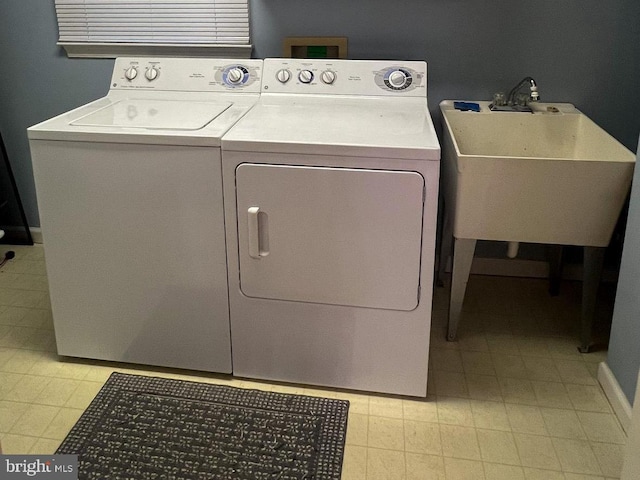 laundry room with separate washer and dryer and sink