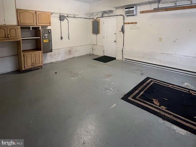 garage featuring a wall mounted AC and electric panel