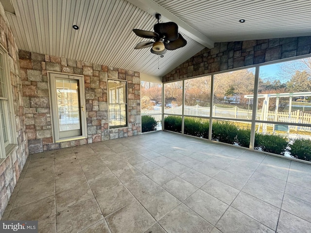 unfurnished sunroom with ceiling fan and vaulted ceiling with beams