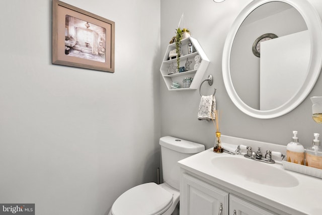 bathroom featuring toilet and vanity