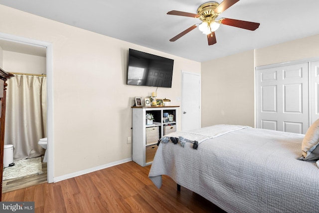 bedroom with ceiling fan, hardwood / wood-style floors, and ensuite bath