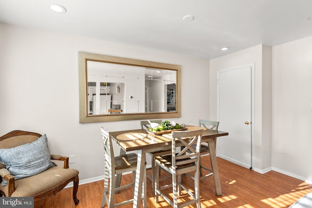 dining space with light hardwood / wood-style floors