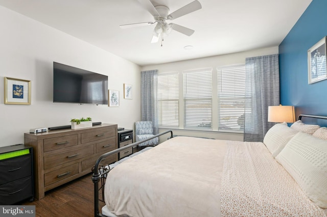 bedroom with ceiling fan and dark hardwood / wood-style floors