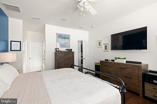 bedroom with ceiling fan and dark hardwood / wood-style flooring