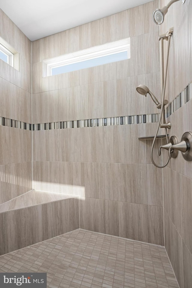 bathroom with tiled shower