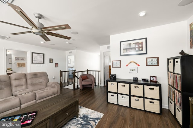 living room with ceiling fan and dark hardwood / wood-style floors