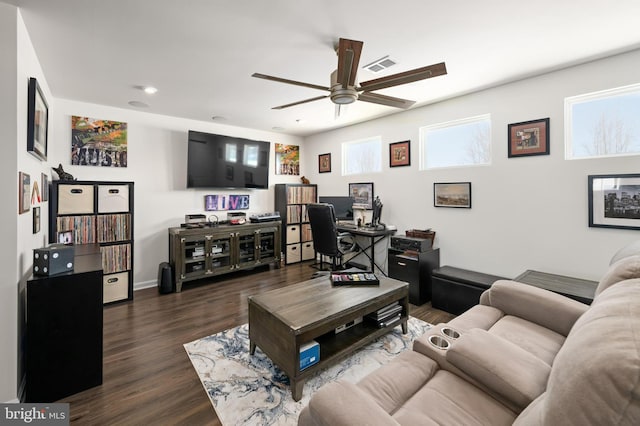 living room featuring ceiling fan, dark hardwood / wood-style flooring, and plenty of natural light