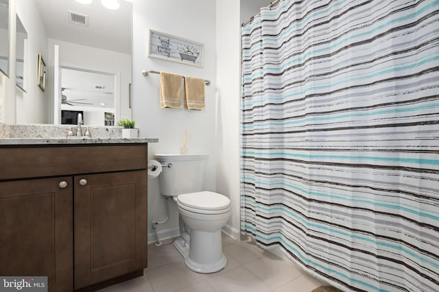 bathroom featuring toilet, vanity, ceiling fan, tile patterned floors, and a shower with shower curtain