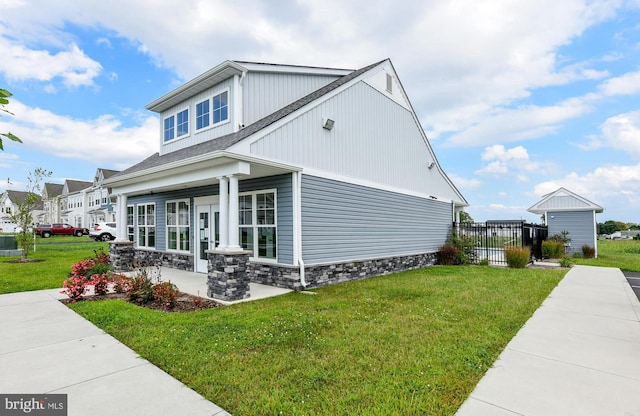 view of side of home with a lawn