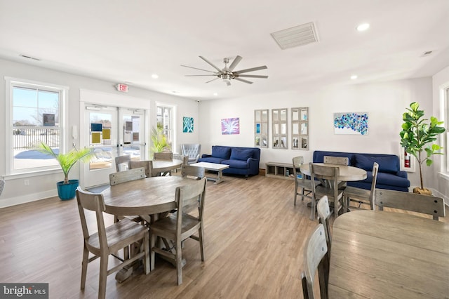 dining room with ceiling fan, light wood-type flooring, and french doors