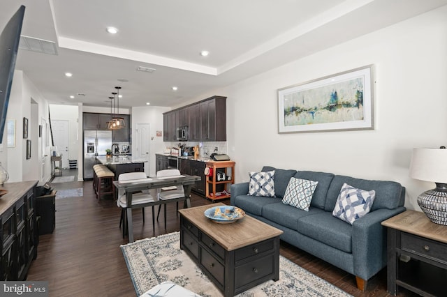 living room with dark hardwood / wood-style flooring