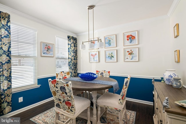 dining room with a healthy amount of sunlight, dark wood-type flooring, and ornamental molding