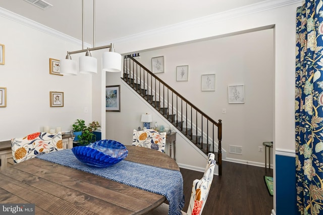 dining area with ornamental molding and dark hardwood / wood-style flooring