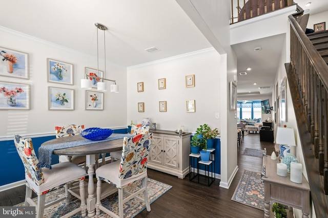 dining space with dark hardwood / wood-style floors and ornamental molding