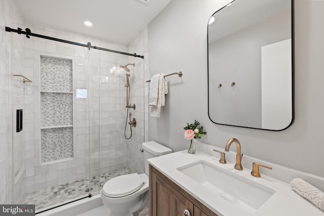 bathroom with toilet, a shower stall, recessed lighting, and vanity