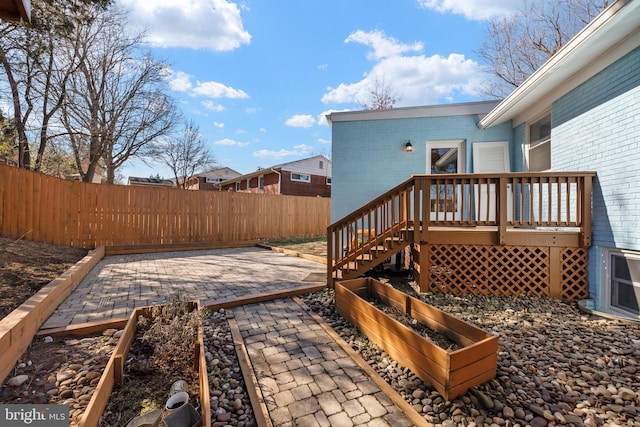 deck featuring a patio area and a fenced backyard