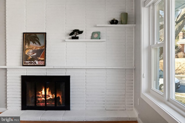 interior details featuring a brick fireplace