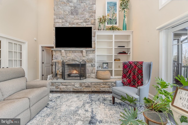 living room featuring a stone fireplace