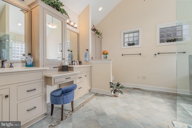 bathroom with lofted ceiling, vanity, and tile patterned flooring