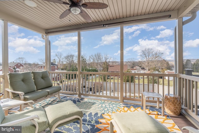 sunroom / solarium featuring ceiling fan