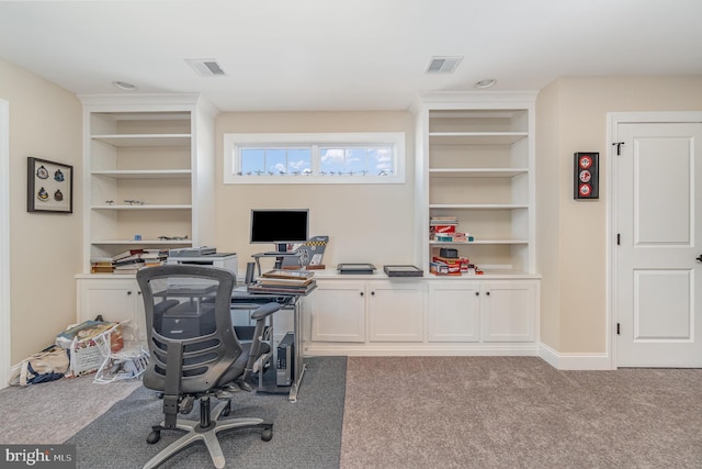 home office featuring light colored carpet and built in features