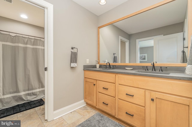 bathroom featuring vanity and a shower with shower curtain