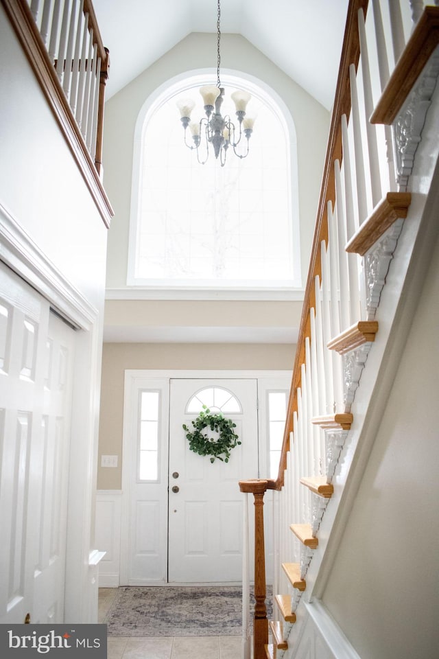 entryway featuring a notable chandelier and a high ceiling