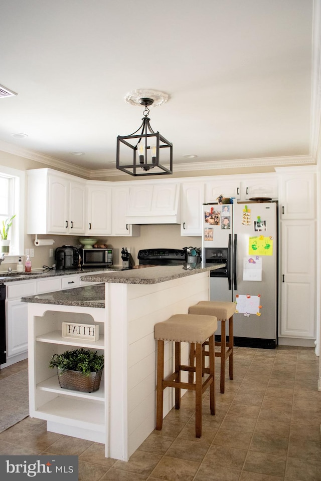 kitchen with black appliances, ornamental molding, white cabinetry, and a kitchen island