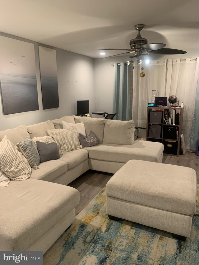 living room featuring hardwood / wood-style flooring and ceiling fan