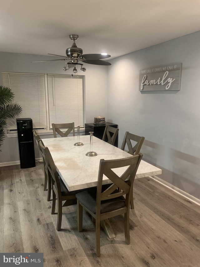 dining space featuring ceiling fan and hardwood / wood-style floors