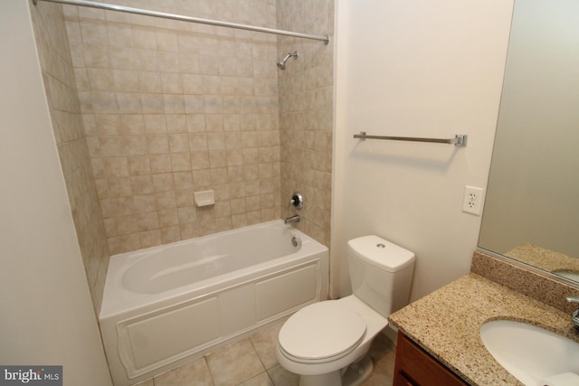 full bathroom with toilet, tile patterned floors, tiled shower / bath, and vanity