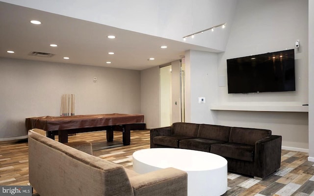 living room with hardwood / wood-style flooring and billiards